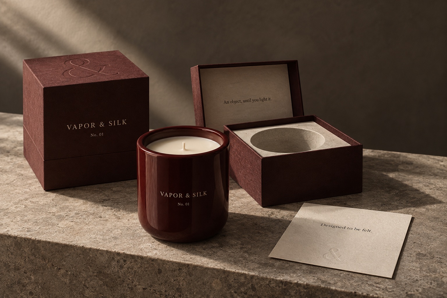 Earlier oxblood packaging study showing textured paper and a pale interior